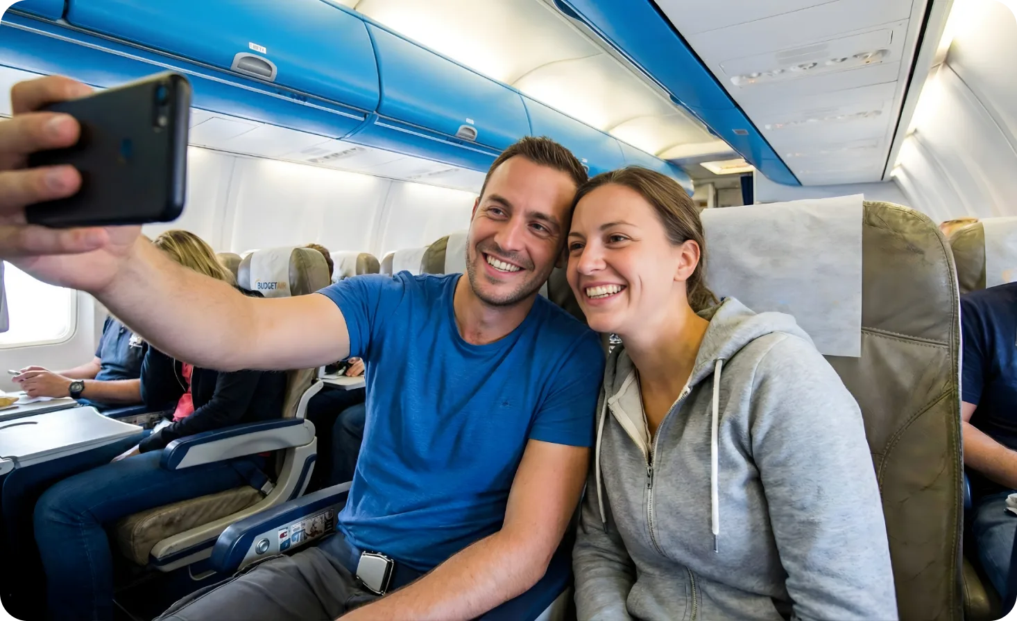 Couple taking selfie on airplane